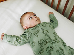 Awake baby lying in cot