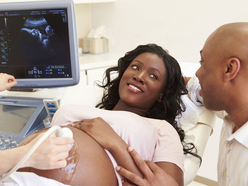 Woman having anatomy scan while smiling at partner