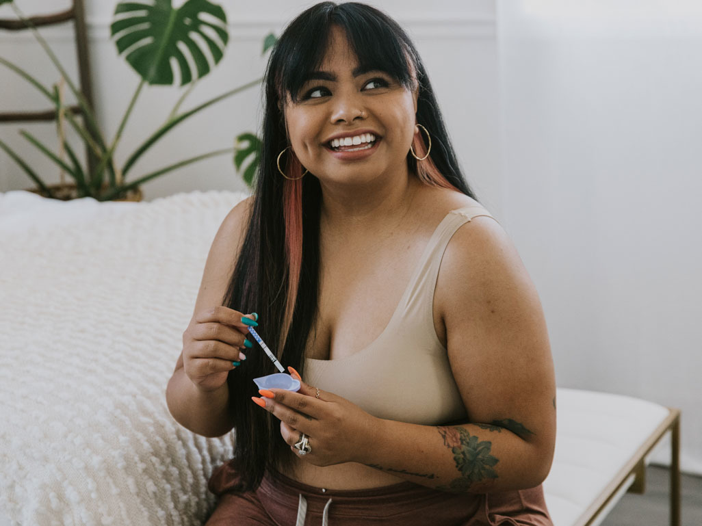 happy woman using an ovulation test kit