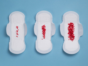 image representing light and heavy bleeding on maxi pad