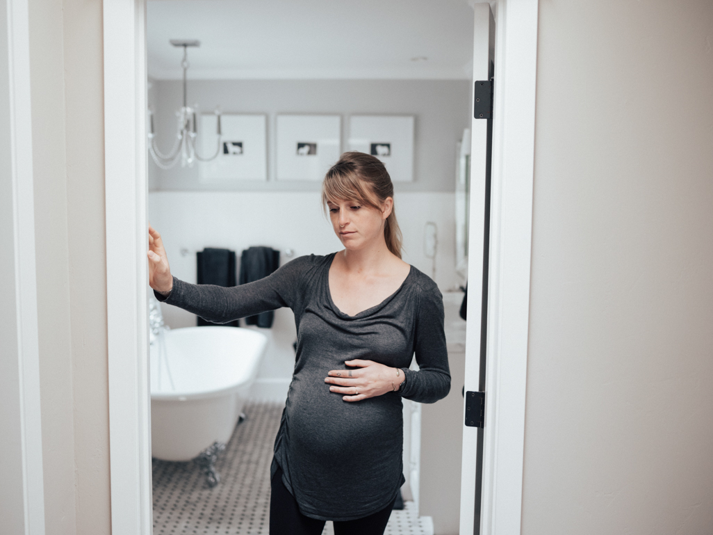 pregnant woman holding belly