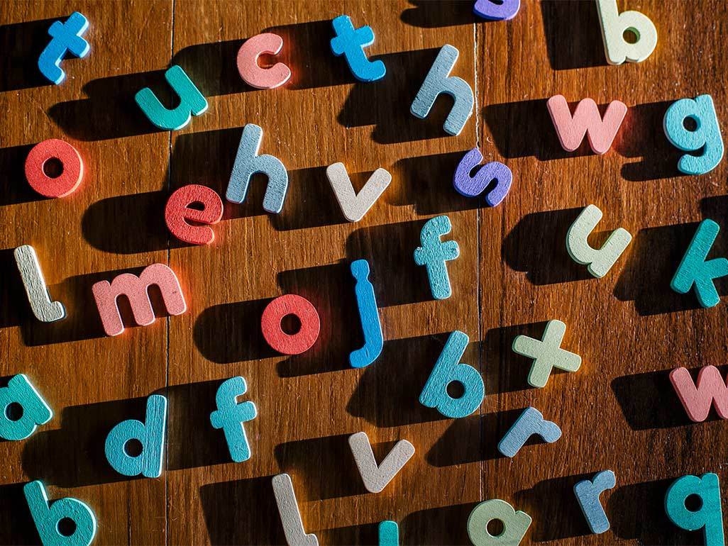 Colorful letter blocks arranged on a wooden surface