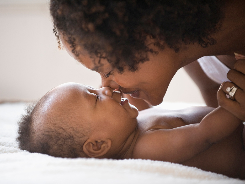 mom snuzzling baby by rubbing noses