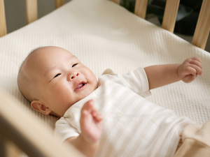 A baby awake in a crib