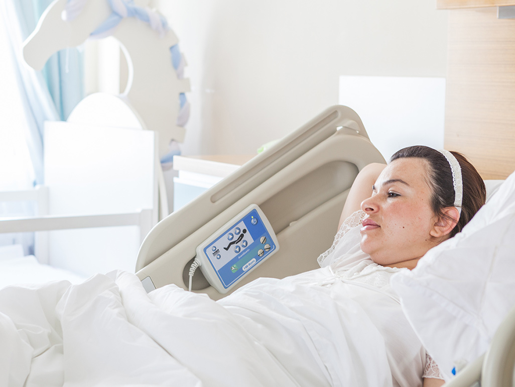 A woman lying in a hospital bed after giving birth.