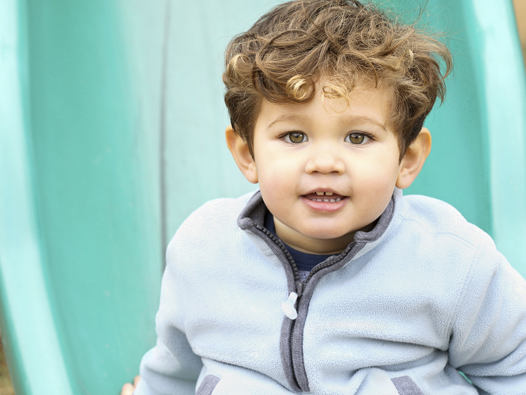 smiling boy wearing a sweater