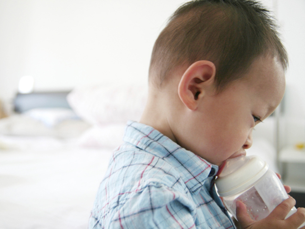 boy feeding from bottle