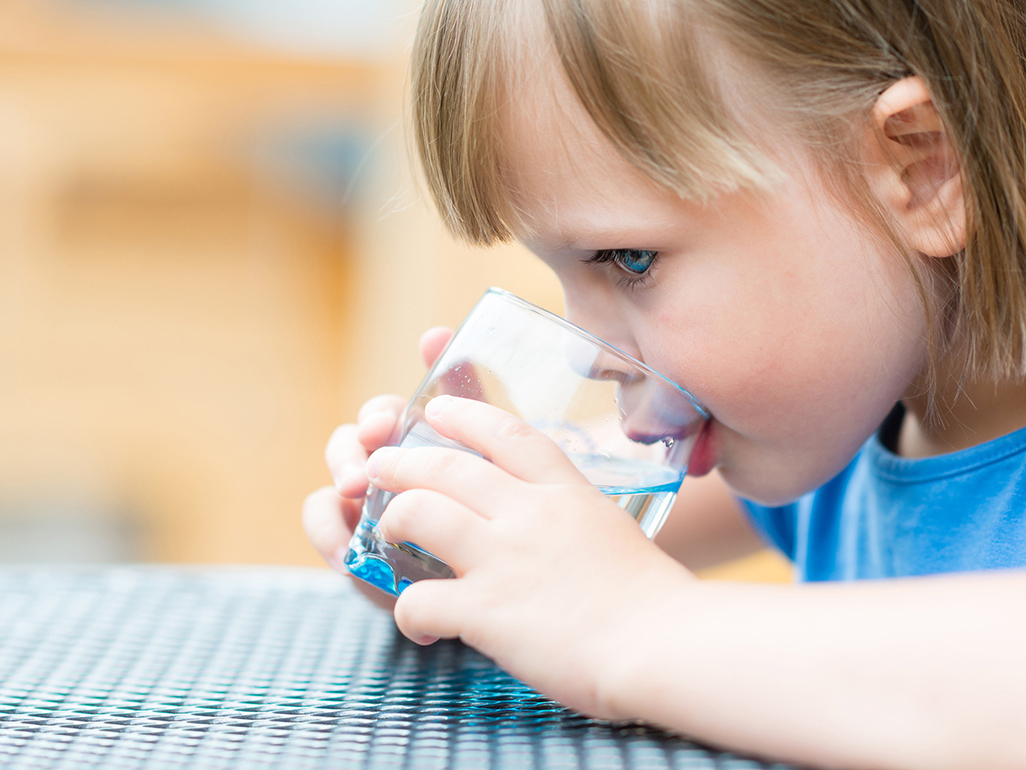 girl drinking water from the glass