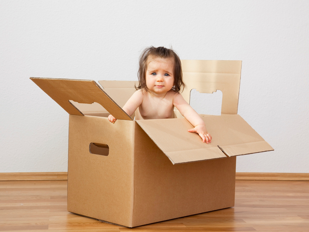 baby coming out of a cardboard box