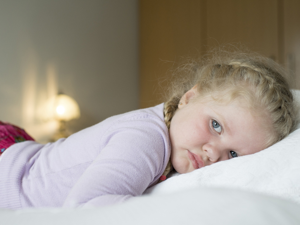 small girl lying down on her stomach