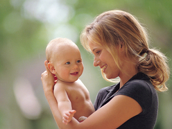 Mom holding smiling baby