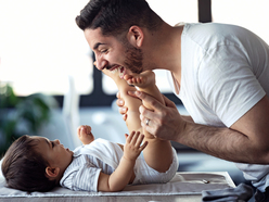 Dad changing baby’s diaper