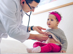 Doctor checking a toddler with a stethoscope