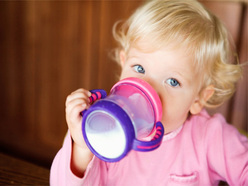 Toddler drinking milk from a sippy cup