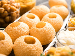 A plate of gol guppas next to other chaat items