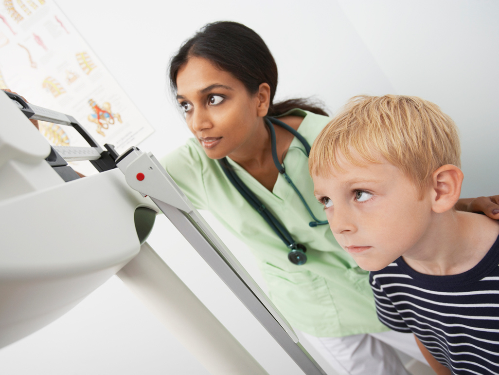 woman measuring weight of a child