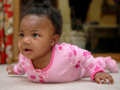 Baby on tummy holding up head