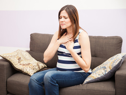 Pregnant woman with her hands on her breastbone