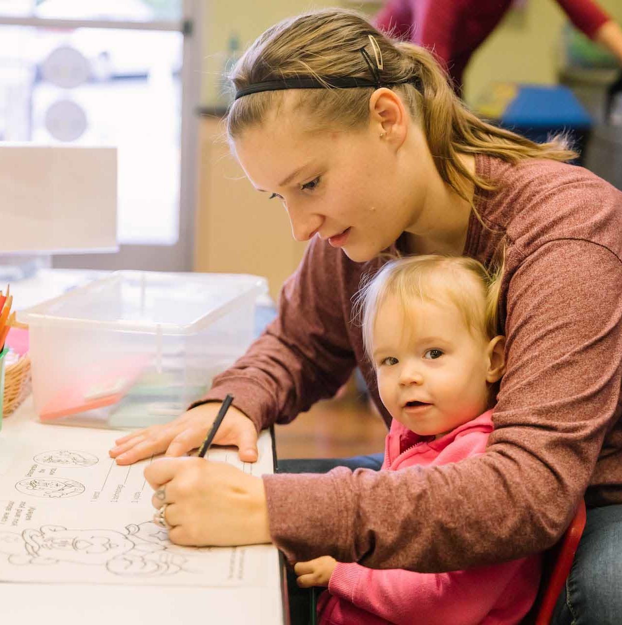 women and child writing