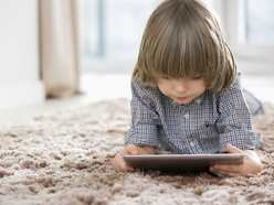 Small boy doing something on handheld electronic device