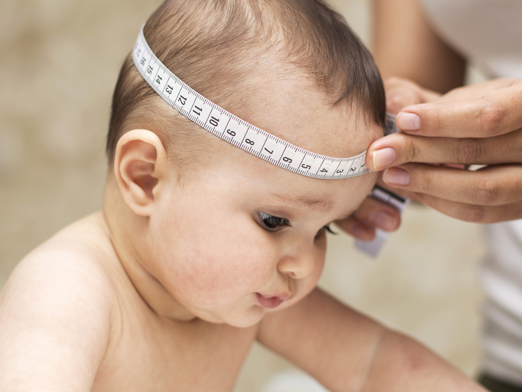 Baby getting her head measured