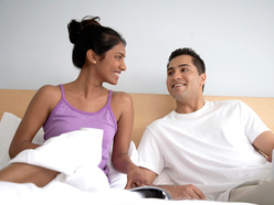 couple on bed smiling