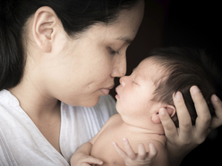 Newborn baby with mother's hands