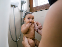 Baby in shower with dad