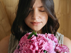 Young woman smelling beautiful hydrangea bouquet 