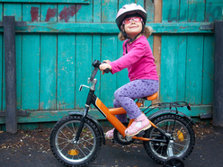 Young girl sitting on a bike