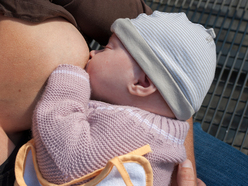 Mum breastfeeding her baby outside