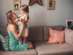 Mom and daughter on the sofa at home