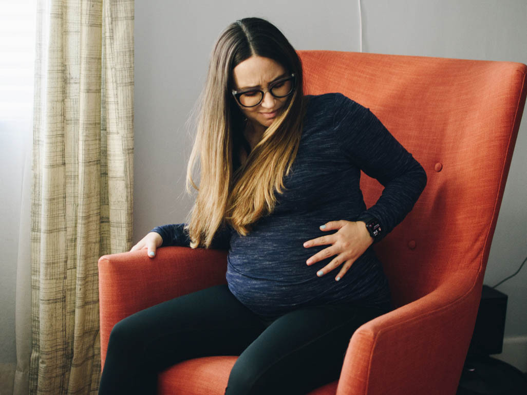 Woman with hand on baby bump