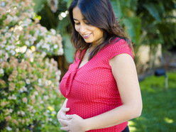 Pregnant woman holding her bump