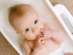 Baby lying on scales