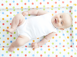 newborn baby laid on a nappy changing mat