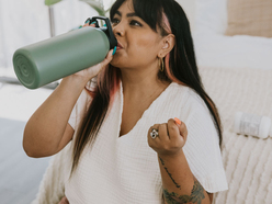 Woman drinking from a flask