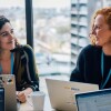 Two women in a meeting discussing the Gender Pay Gap reports 