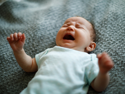 baby crying while lying on their back