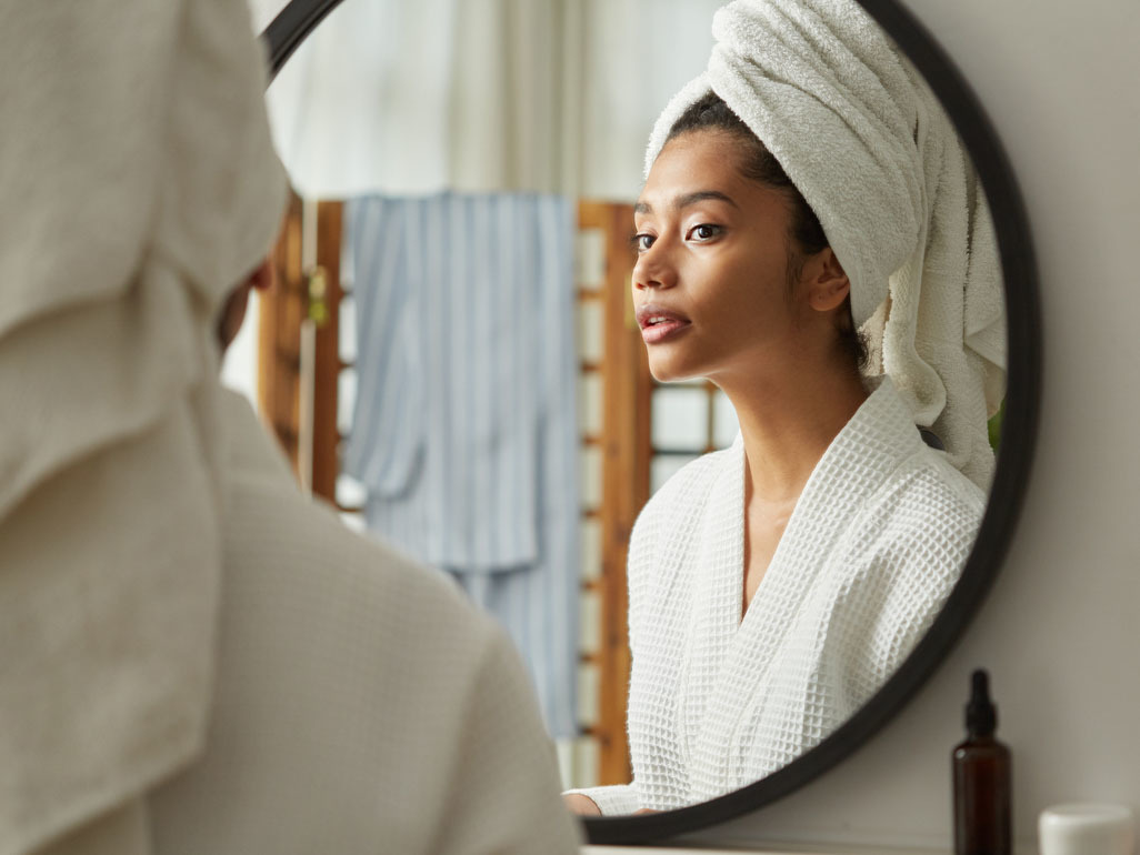 Pregnant woman looking in mirror