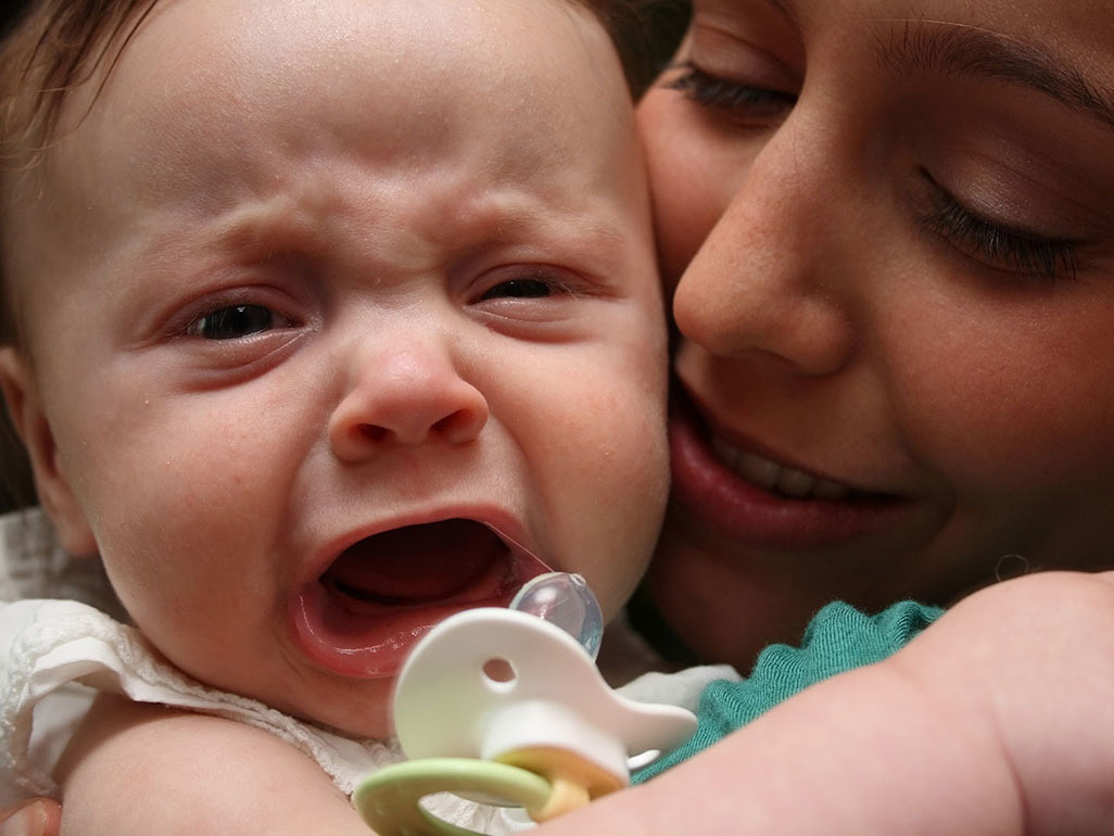 mom holding screaming baby