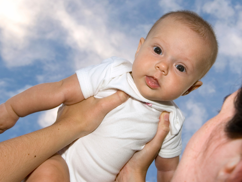 baby being held up and stiffening arms