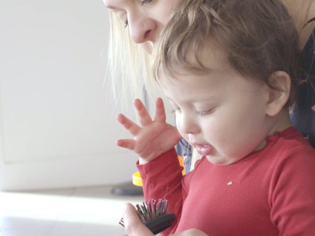 child feeling a comb