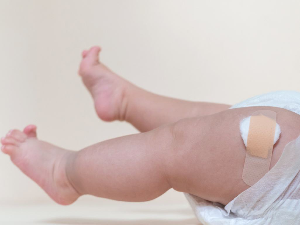 doctor giving a vaccine to a baby