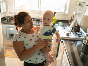 smiling nanny holding baby boy