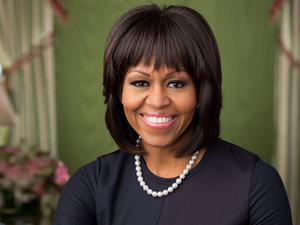 michelle obama smiling wearing pearl necklace