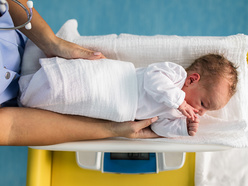 infant being weighed on scale