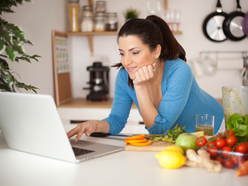 Lady on laptop with healthy food