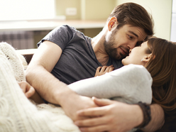 young bearded man holding woman in his arms