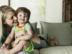 Mum cuddling a child on her lap